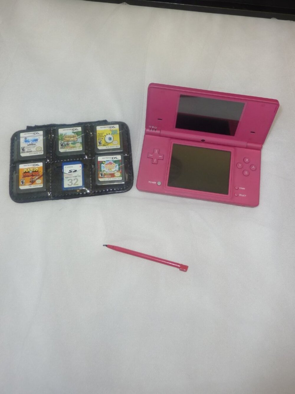 Nintendo DSi Console PINK with charger, 5 games and SD card.
